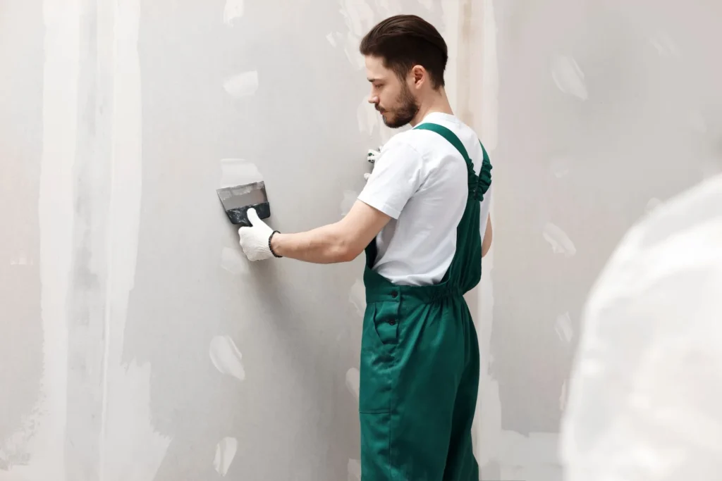 Drywall finishing in Edmonton with joint compound drying under controlled indoor temperature and humidity conditions